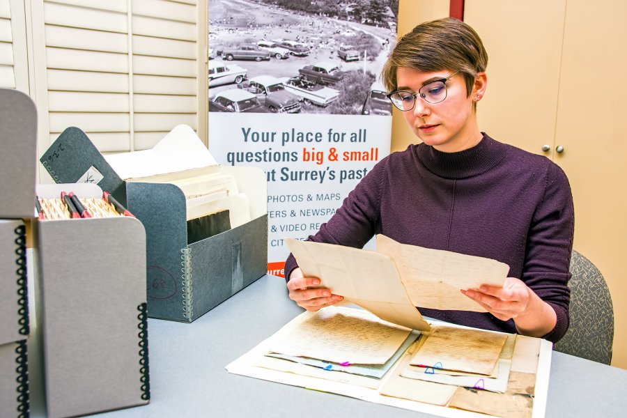 The Archivist reviewing documents in the reference room