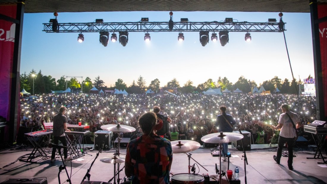 photo looking over a crowd from behind stage