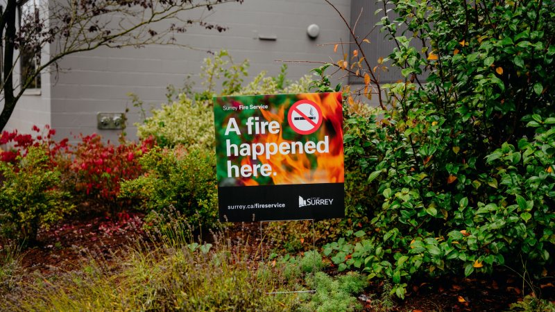 A fire happened here sign in a garden