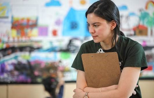 a youth counsellor holding a clipboard