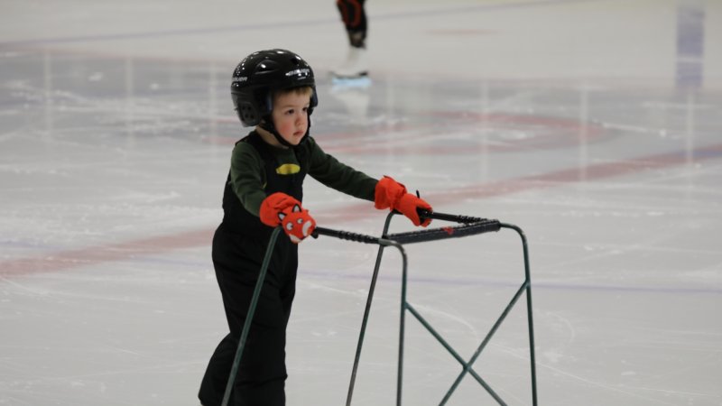 A little boy skating.