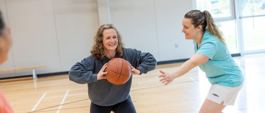 Women playing basketball.
